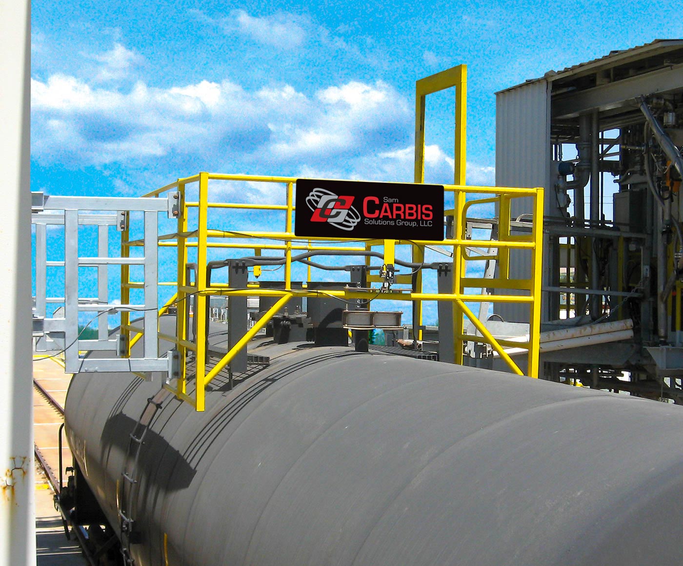 A cage sits over a rail car for loading.