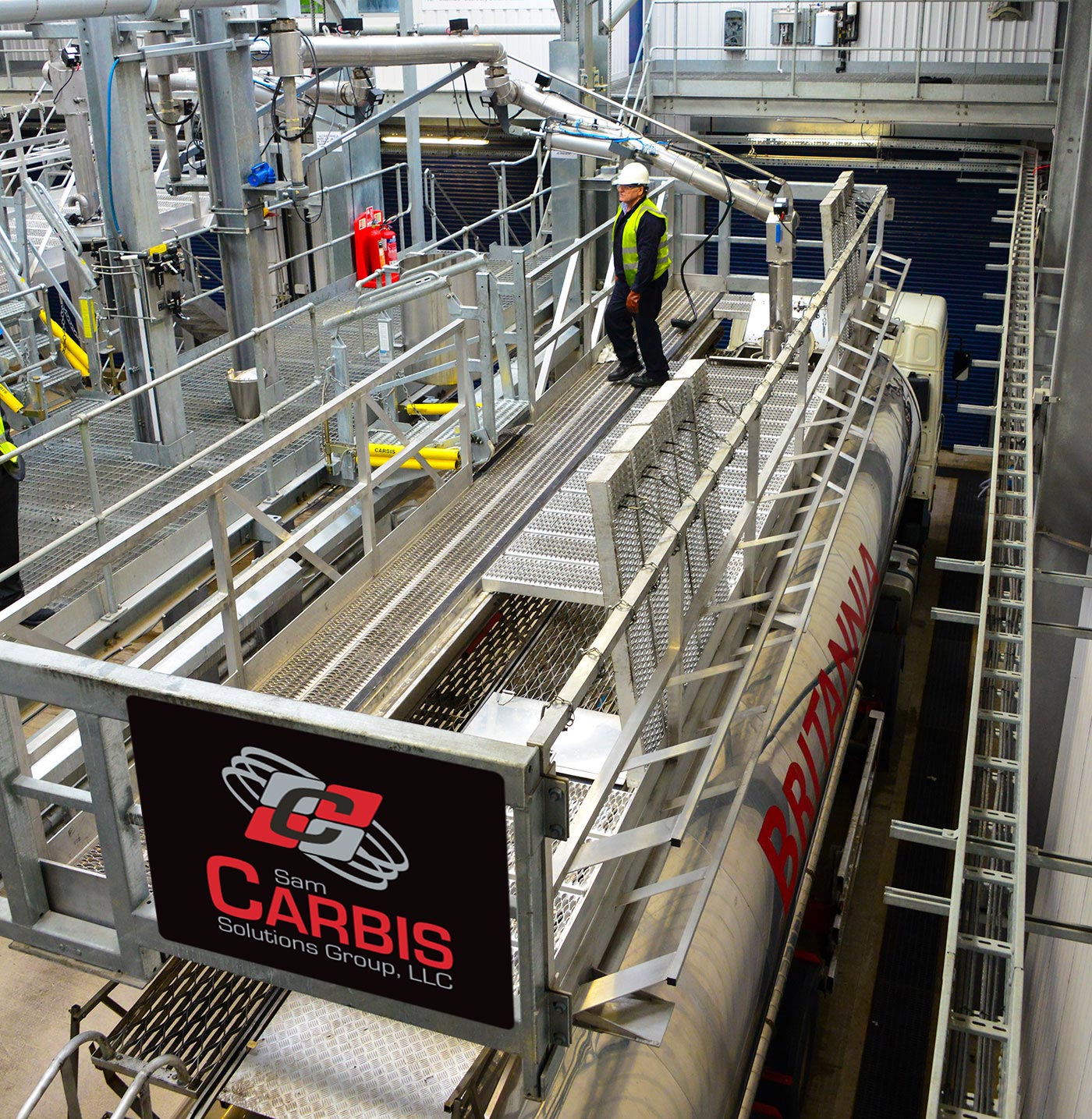 A worker stands on a Carbis Solutions elevated truck platform.