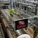 A man works from a Carbis Solutions elevated truck platform.