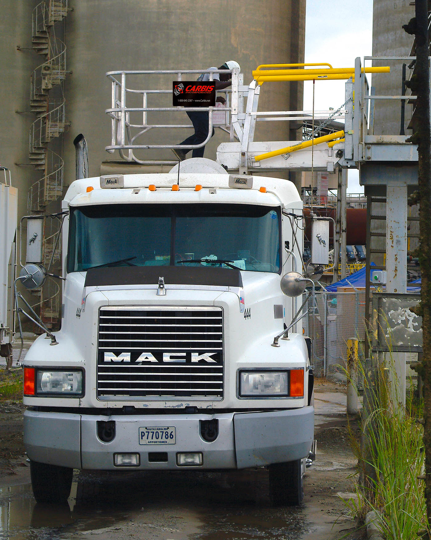 Carbis single hatch truck loading system above a Mack truck.