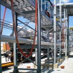 A Carbis Solutions structural steel pipe rack supporting pipes, power cables.