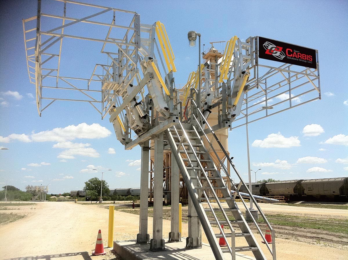 Two Carbis Solutions Isotainers sit in a loading dock perched above a road to load tanker trucks.