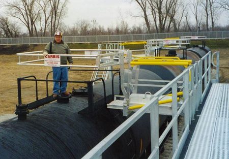 Unit train loading platform above a tanker railcar.