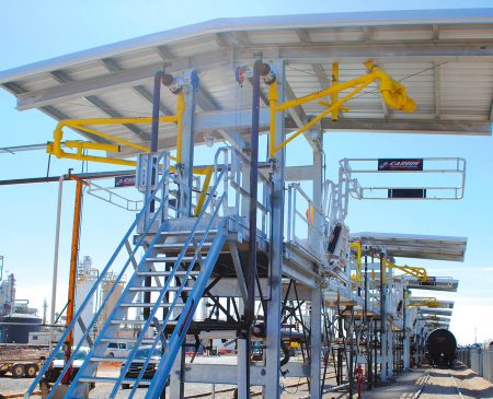 A series of multi-hatch bays under roofs at a refinery.