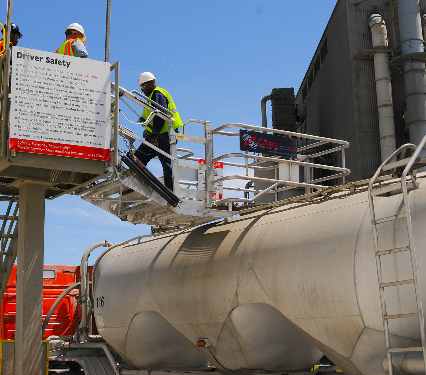 Carbis single hatch truck loading system above a tank truck's vessel.