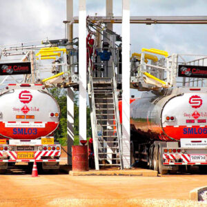 A truck enclosure dock/bay with two tanker trucks underneath.