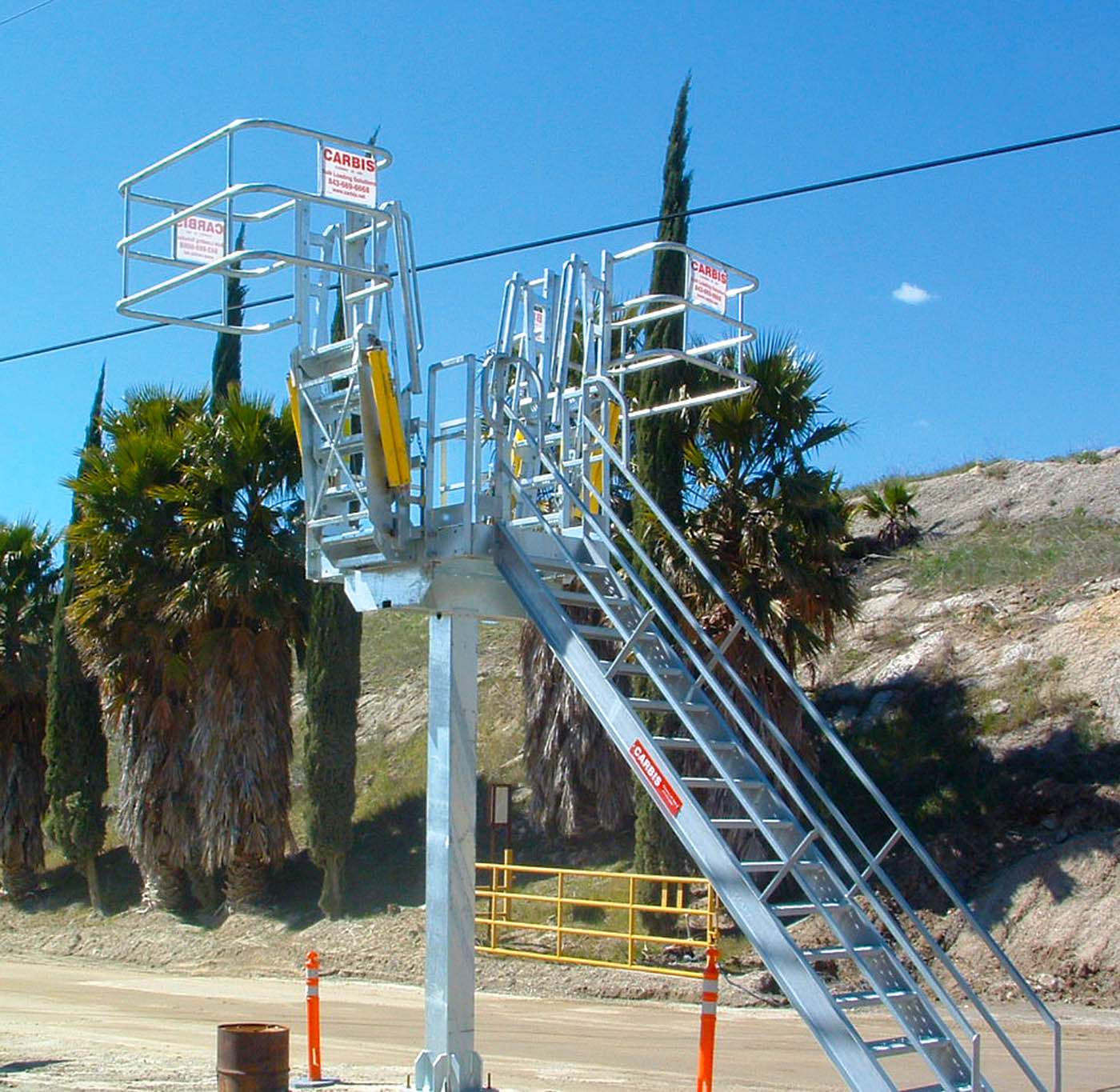 Carbis single hatch truck loading system in front of some palm trees.