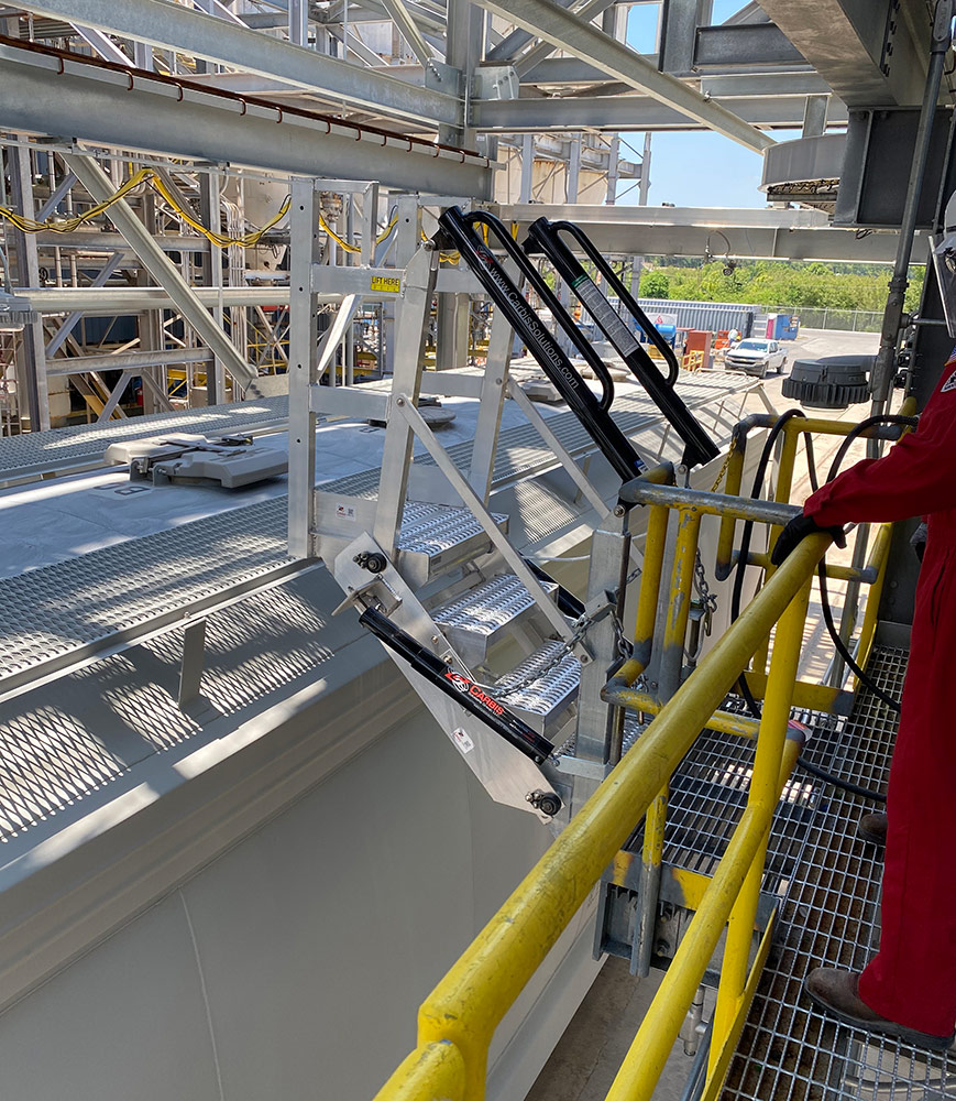 A Carbis Solutions folding stairs gangway enclosure above a tanker car.