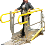 A woman stands on a telescoping ramp.