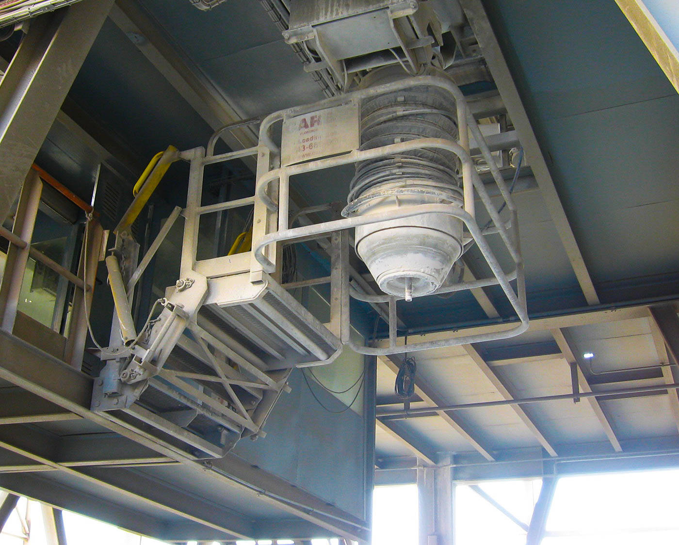 A custom safety cage surrounds a cement mixing apparatus.