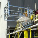 A custom safety cage stands high on a loading dock.