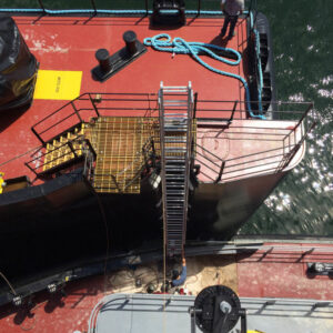 A marine ladder is positioned from one boat to the next for boarding.