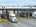 A flatbed tarping dock with several stalls and a loaded 18 wheeler being tarped.