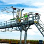 A track mounted gangway is shown on a loading platform.