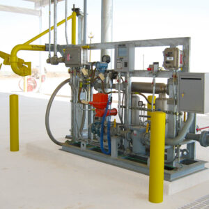 A bottom loading arm system sits on a skid, forming a loading system island.