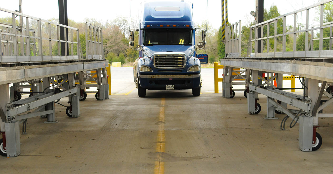 a truck comes into the tarping station.